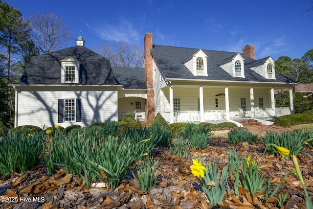 view of front of property featuring covered porch and a chimney