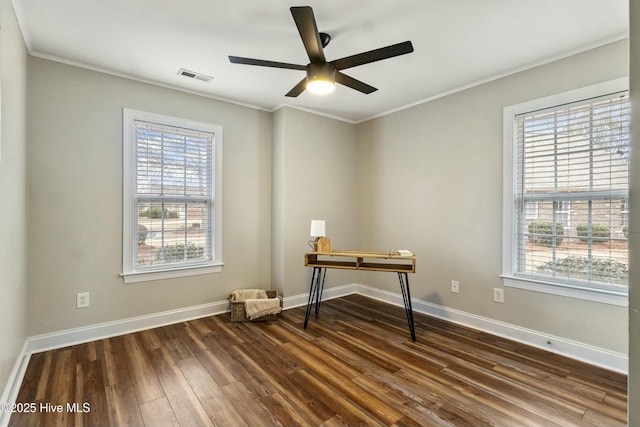 unfurnished office featuring baseboards, crown molding, visible vents, and dark wood-style flooring