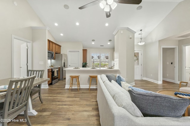 living area featuring baseboards, visible vents, a ceiling fan, light wood-type flooring, and recessed lighting