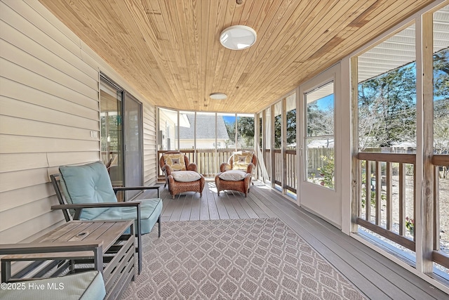 unfurnished sunroom featuring plenty of natural light and wooden ceiling