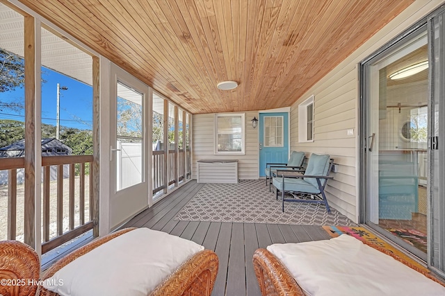 sunroom featuring wood ceiling