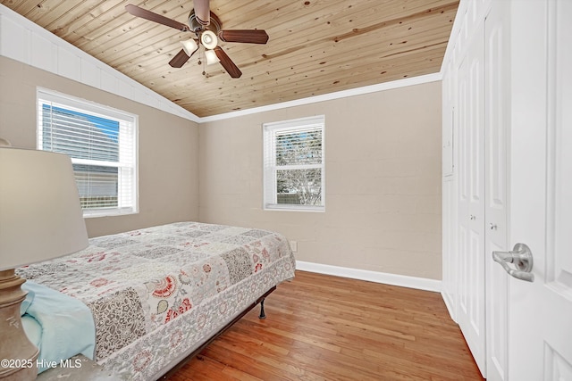 bedroom featuring baseboards, wooden ceiling, wood finished floors, and crown molding