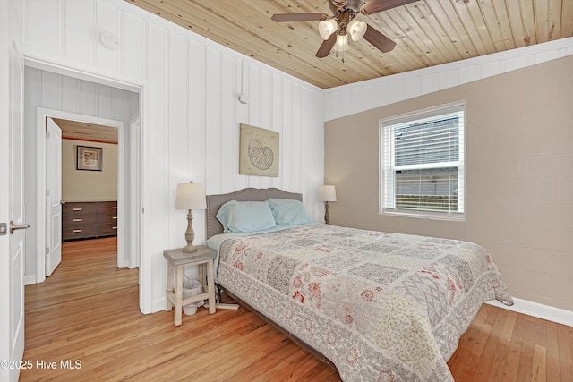 bedroom featuring wood ceiling, ceiling fan, light wood-style flooring, and baseboards