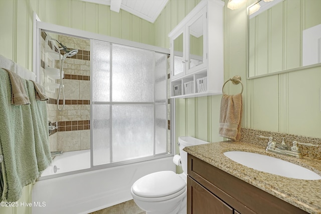 full bathroom featuring bath / shower combo with glass door, vanity, and toilet