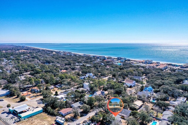 drone / aerial view with a water view and a beach view