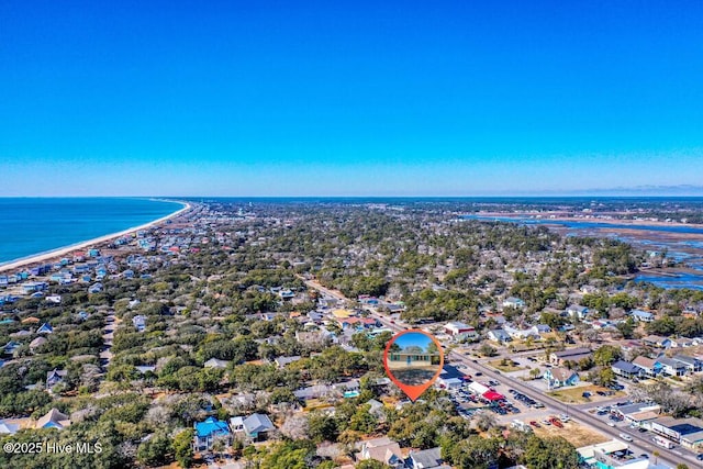 birds eye view of property with a water view and a view of the beach