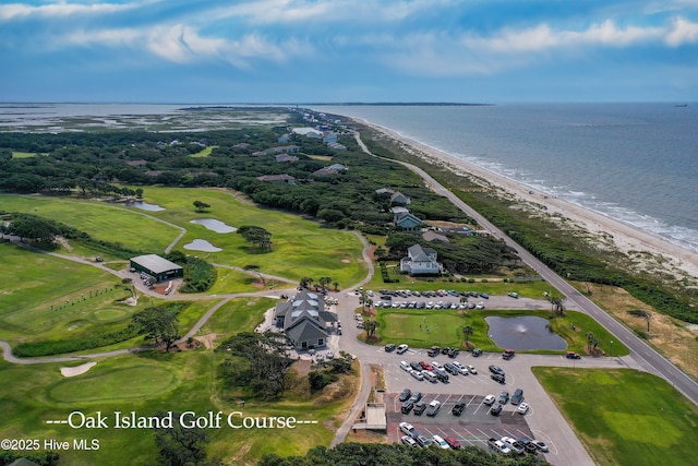 aerial view featuring a water view, view of golf course, and a view of the beach