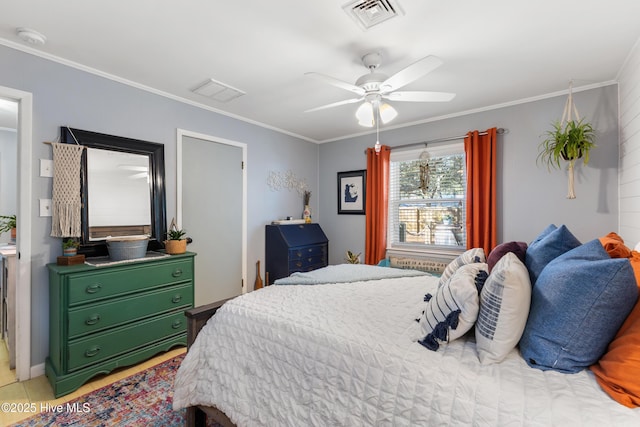 bedroom featuring ceiling fan, visible vents, and ornamental molding