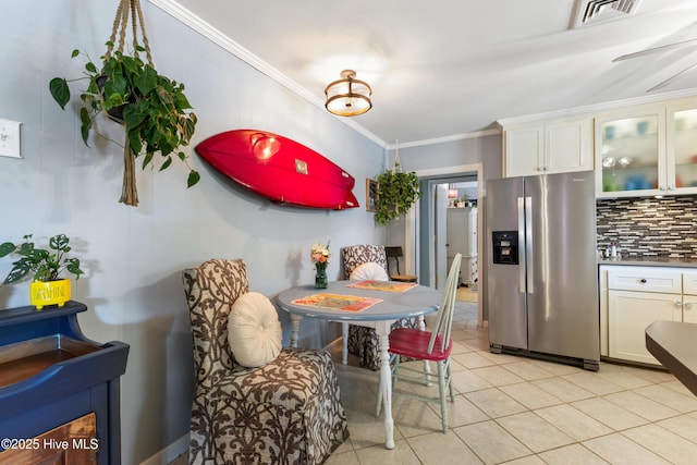 kitchen with tasteful backsplash, visible vents, stainless steel fridge with ice dispenser, crown molding, and white cabinetry