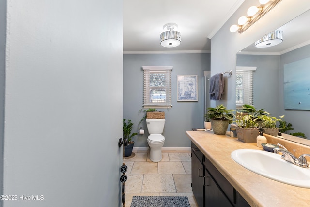 bathroom with crown molding, plenty of natural light, and baseboards