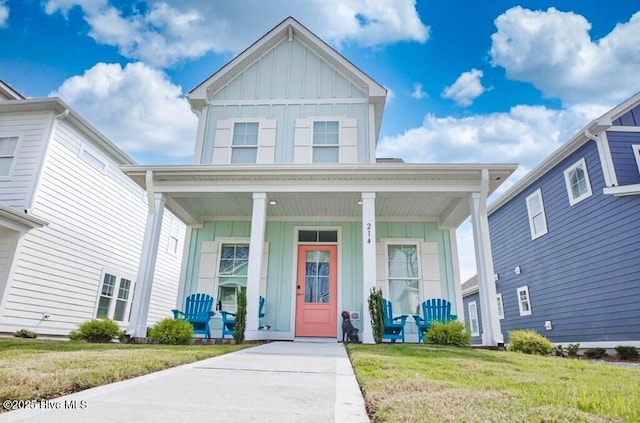 view of front of property with covered porch and a front lawn