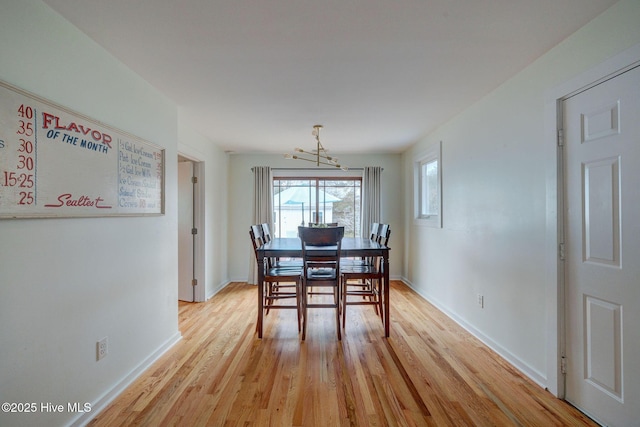 dining room featuring light wood-type flooring and baseboards