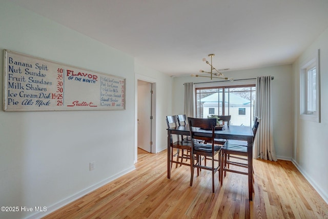 dining room featuring light wood-style floors and baseboards