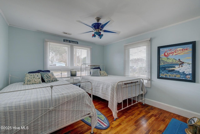 bedroom featuring dark wood-style floors, baseboards, visible vents, and crown molding