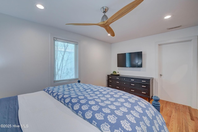 bedroom featuring a ceiling fan, recessed lighting, visible vents, and wood finished floors