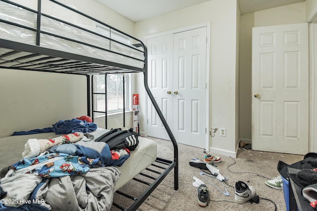 bedroom with a closet and baseboards