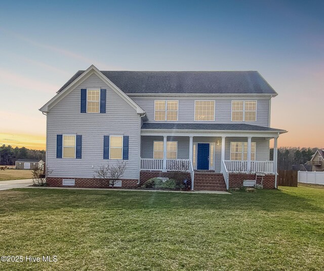 view of front of property featuring crawl space, covered porch, a front lawn, and fence