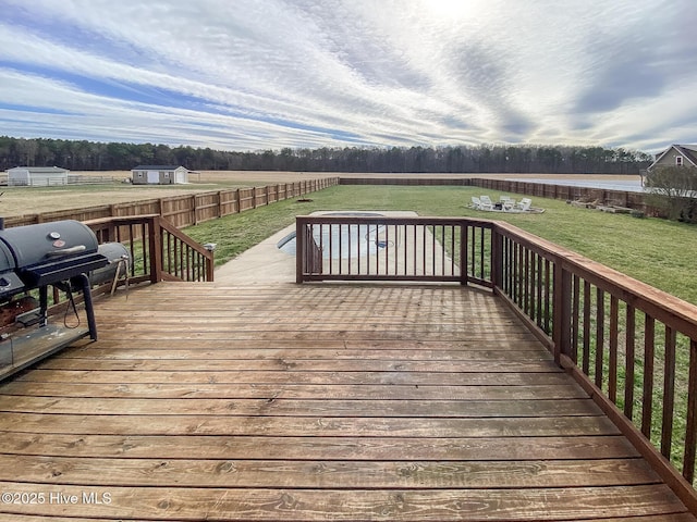 wooden deck featuring a yard, grilling area, and fence