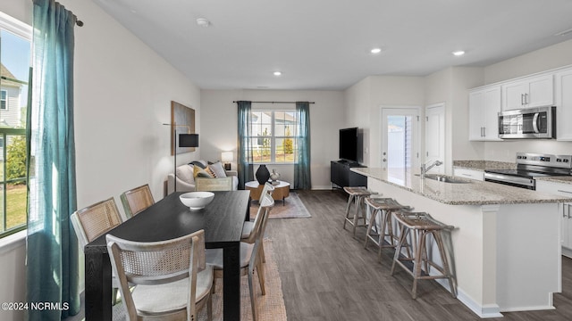 dining area with sink and dark wood-type flooring