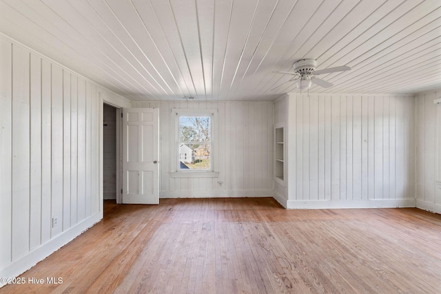 unfurnished room with ceiling fan, light wood finished floors, wooden ceiling, and baseboards