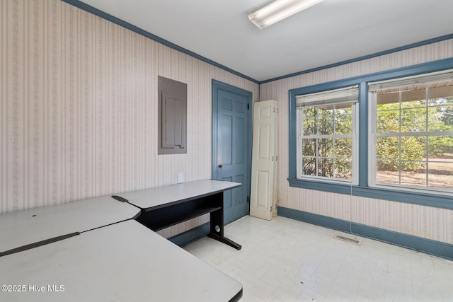 office space with light floors, visible vents, electric panel, baseboards, and wallpapered walls