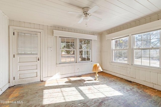 unfurnished sunroom featuring ceiling fan and visible vents