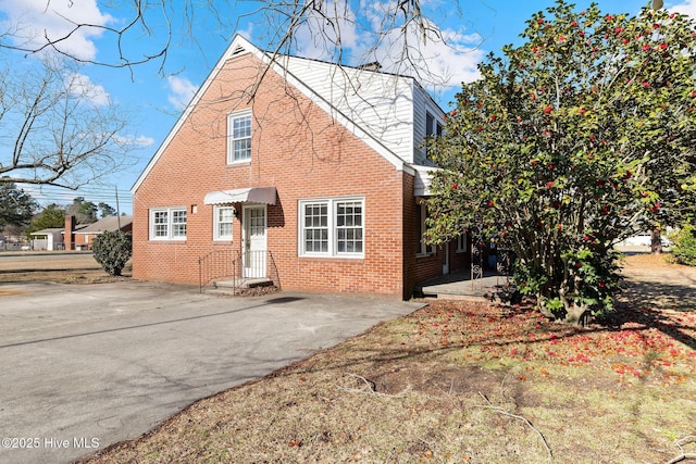 view of front of house featuring brick siding and driveway