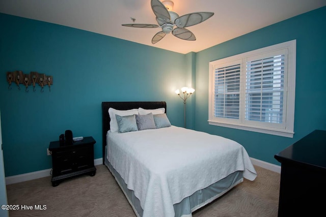 carpeted bedroom with ceiling fan and baseboards