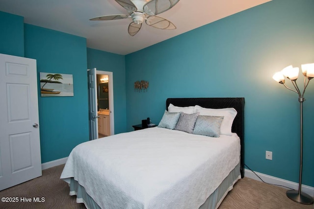 bedroom featuring baseboards, dark carpet, connected bathroom, and ceiling fan with notable chandelier