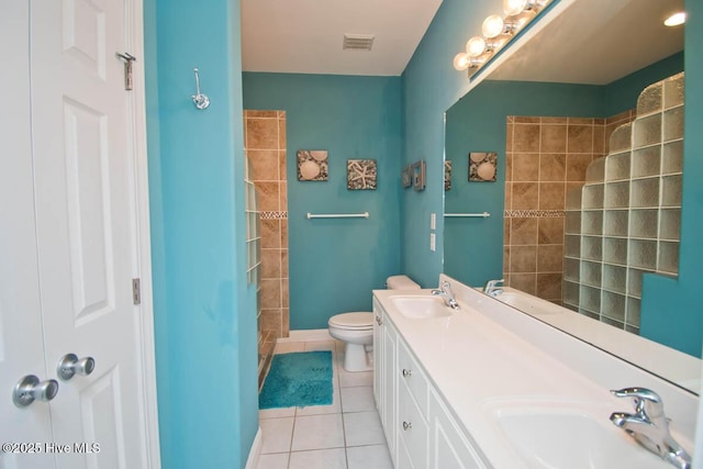 bathroom featuring visible vents, a sink, toilet, and tile patterned floors