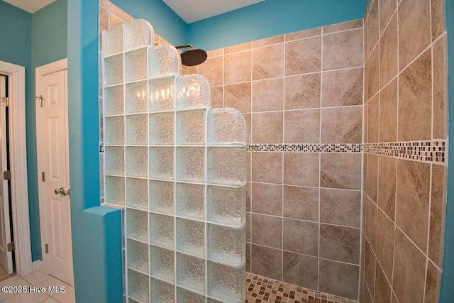 bathroom with a walk in shower and tile patterned flooring