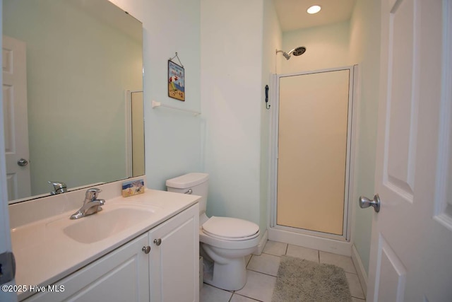 bathroom featuring toilet, a stall shower, tile patterned flooring, and vanity