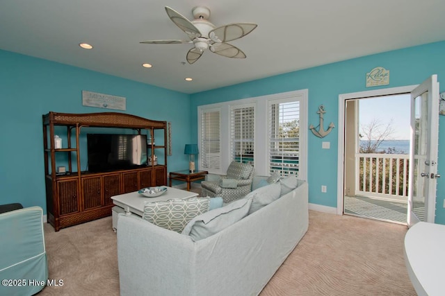 living room with a ceiling fan, recessed lighting, light carpet, and baseboards