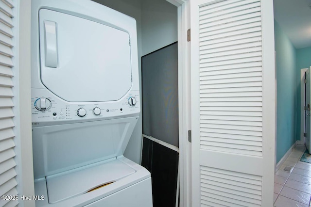 washroom with laundry area, tile patterned flooring, and stacked washer and clothes dryer