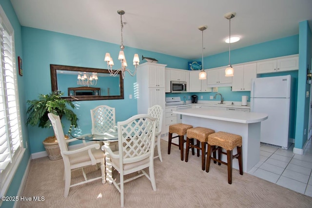 dining area featuring baseboards, an inviting chandelier, and light tile patterned floors