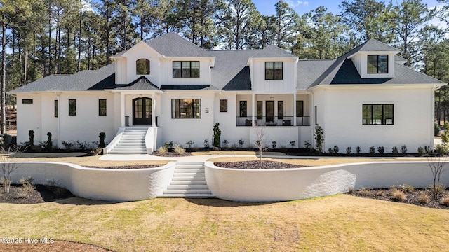 modern farmhouse featuring a front lawn, french doors, brick siding, and roof with shingles