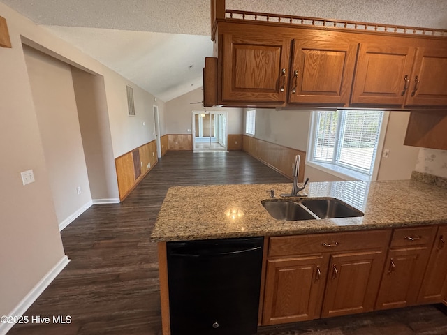 kitchen featuring lofted ceiling, dark wood-style floors, a sink, brown cabinets, and dishwasher