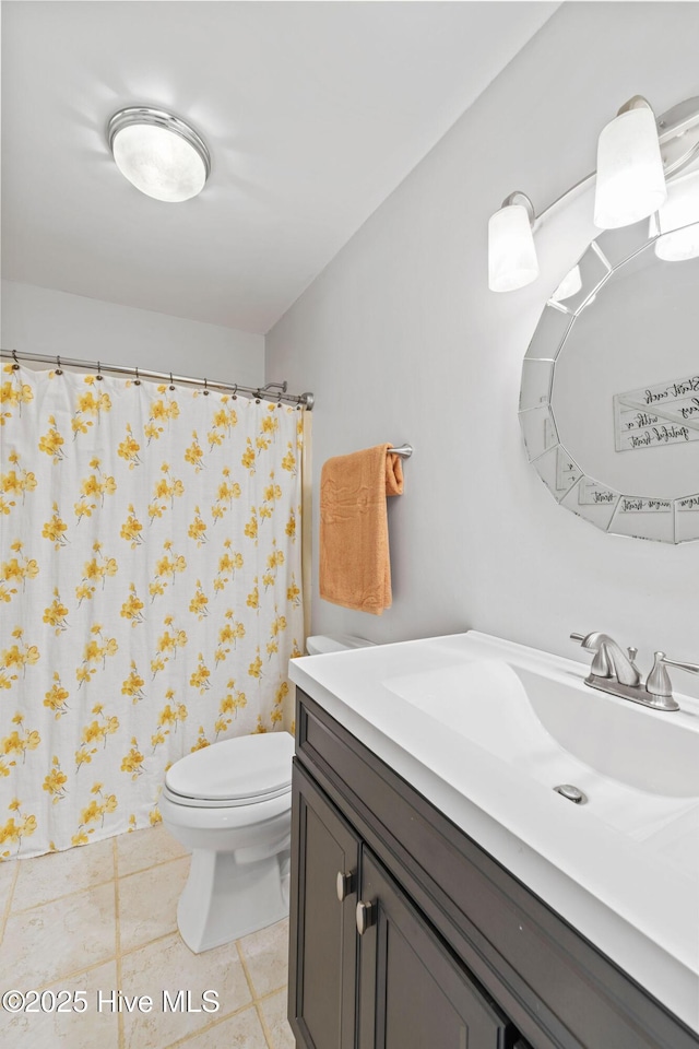 full bath with toilet, tile patterned flooring, and vanity