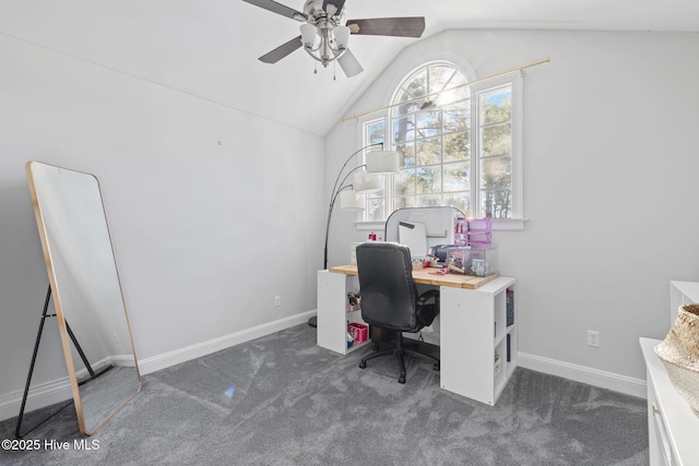 home office featuring lofted ceiling, ceiling fan, dark carpet, and baseboards