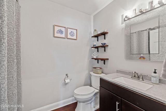 full bathroom featuring baseboards, vanity, toilet, and wood finished floors