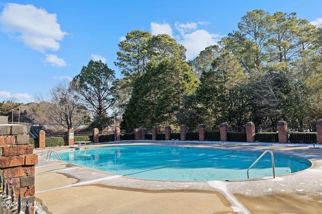 pool featuring a patio area and fence