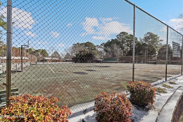 view of sport court featuring fence