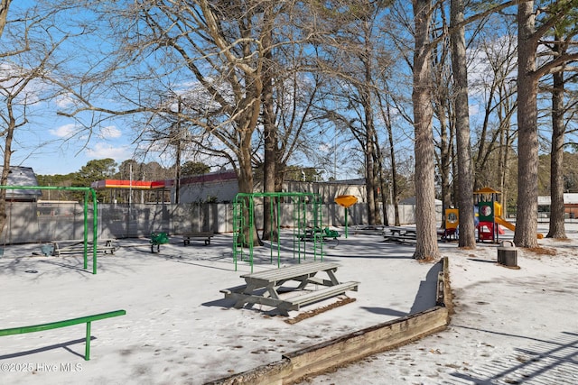 view of property's community featuring playground community and fence