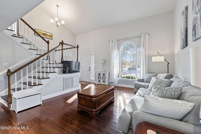 living area with baseboards, dark wood-style floors, high vaulted ceiling, stairs, and a chandelier