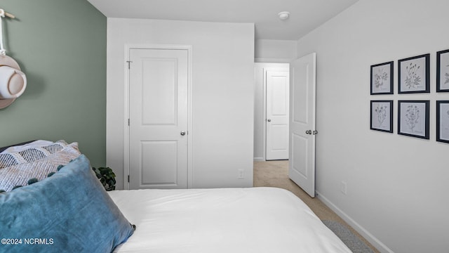 bedroom featuring light colored carpet