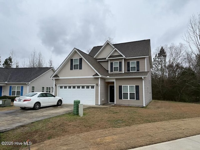 view of front of home with a garage, a front yard, and driveway