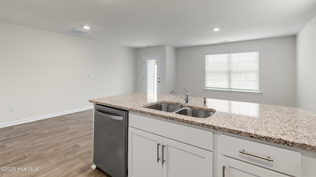 kitchen featuring white cabinets, dishwasher, light stone countertops, and sink