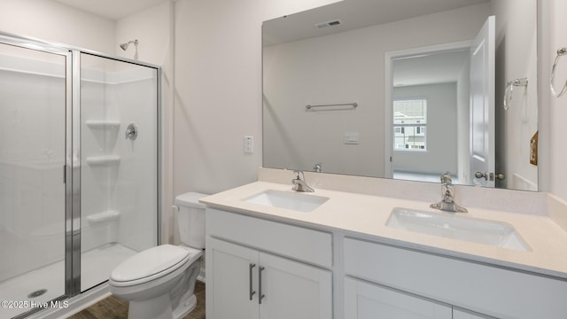 bathroom with vanity, toilet, and walk in shower