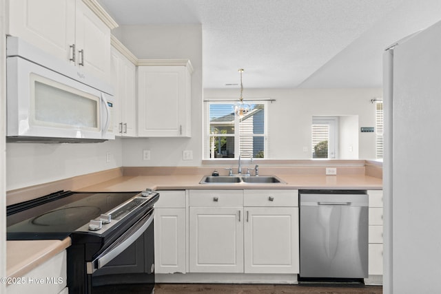 kitchen featuring electric stove, a sink, dishwasher, white microwave, and light countertops