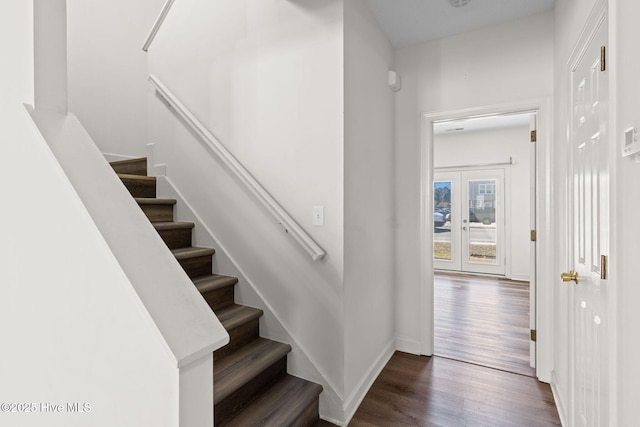 stairs with baseboards, french doors, and wood finished floors